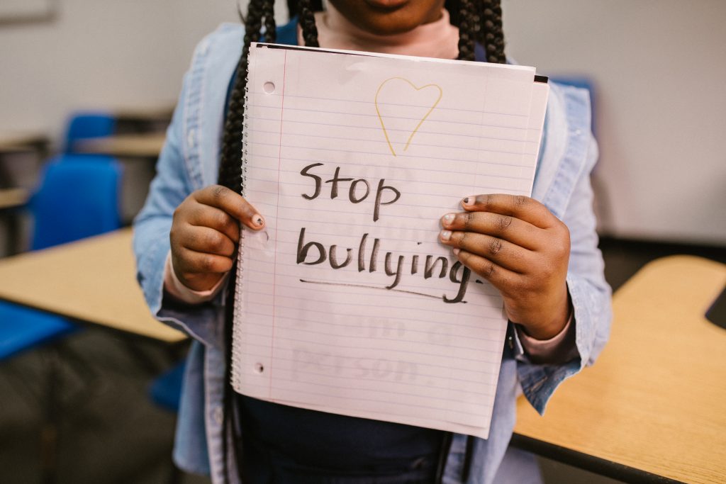 Child showing a message written in a notebook