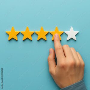 Customer service concept hand selecting a rating of four out of five stars on a light blue background