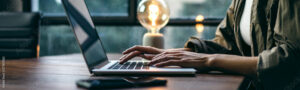 Young woman working with a laptop. Female freelancer connecting to internet via computer. Businesswoman at work