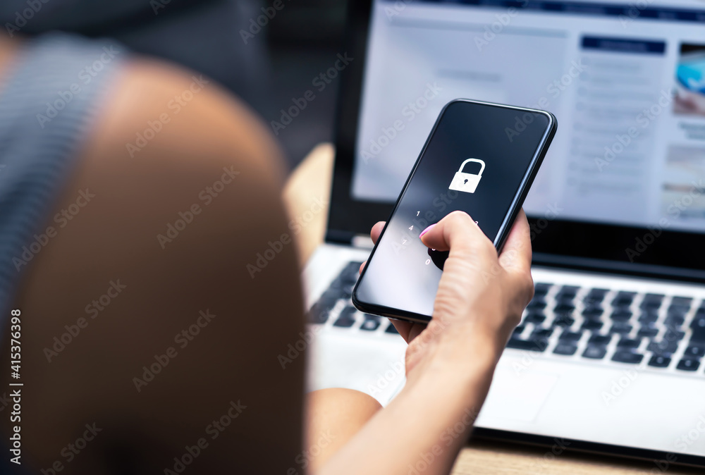 Phishing, mobile phone hacker or cyber scam concept. Password and login pass code in smartphone. Online security threat and fraud. Female scammer with cellphone and laptop. Bank account security.