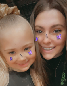 A picture of myself coaching my cousin for cheerleading.