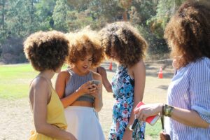 people, woman, friends, text, cellphone, nature, iphone, apple, curl, grass, park, trees, green, black