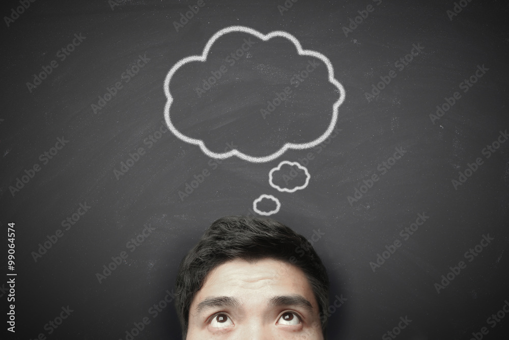 Thinking man with thinking bubble on blackboard