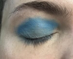 Close up of closed eye. light blue on the lid with a brighter blue crease.