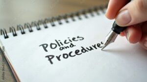 Policies and procedures memo written on notebook with fountain pen