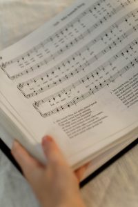 Close up photo of person holding a sheet music