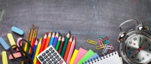 School supplies on blackboard background