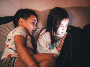 Children engaged with tablet at home at night