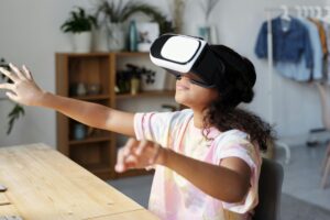 Girl in white and pink shirt wearing white vr goggles