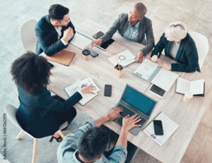 Business people, meeting and paper with charts for sales planning, portfolio and company report. Top view, digital marketing and team with tech in discussion for brainstorming, idea or plan of growth