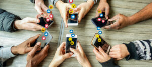 Group of millennial friends using mobile phones - Young people addiction to technology trends following and chatting with emoji on smartphones - Tech and millennial concept