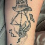 My Harry Potter tattoo of Deathly Hallows symbol, with harry's glasses, Dobby's sock, Sorting hat on top and a Golden snitch flying