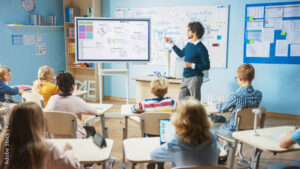 Image of a teacher teaching on a smart board.