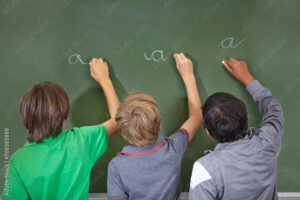 Children, chalkboard and school writing with education, cursive and answer for learning. Back, knowledge and youth development in a study lesson with students in classroom with chalk and solution