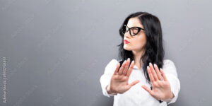 Young woman making a rejection pose a solid background