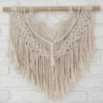 Macromé wall hanging with a series of knotted cord. 