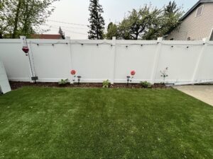 Yard with outdoor décor and three hosta plants