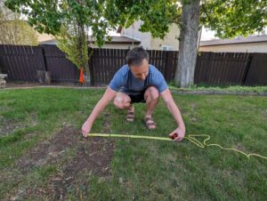 Measuring the radius of the firepit and paving stones.