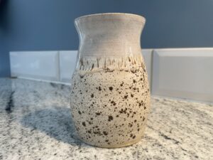 White and speckled handmade pottery cup 