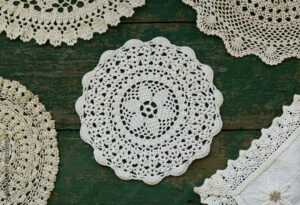 Set of vintage lace napkins on rusted wooden background