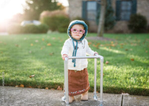 toddler girl dresses up as old lady with walker for Halloween