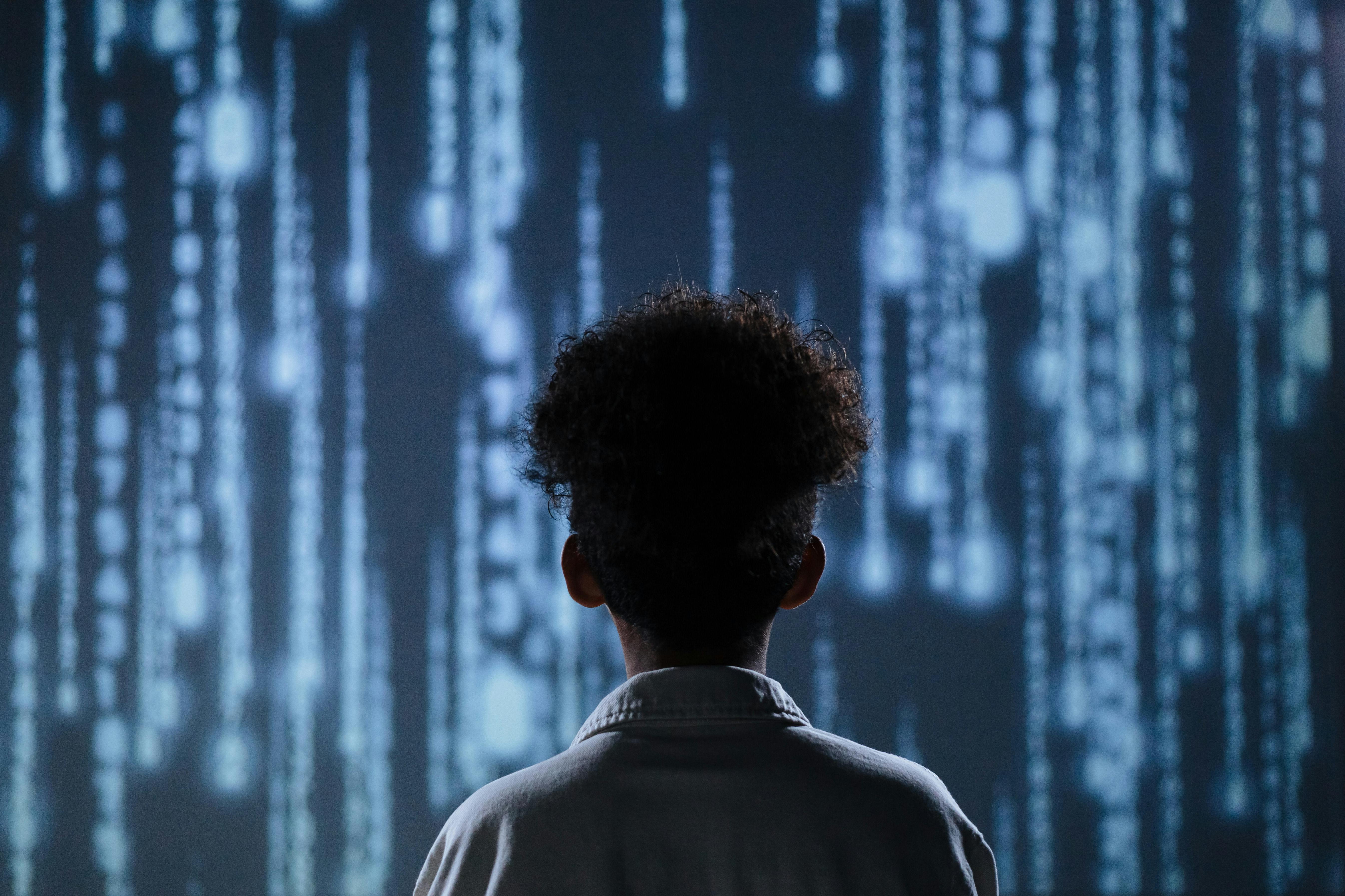 Back view of a teen boy with a digital background