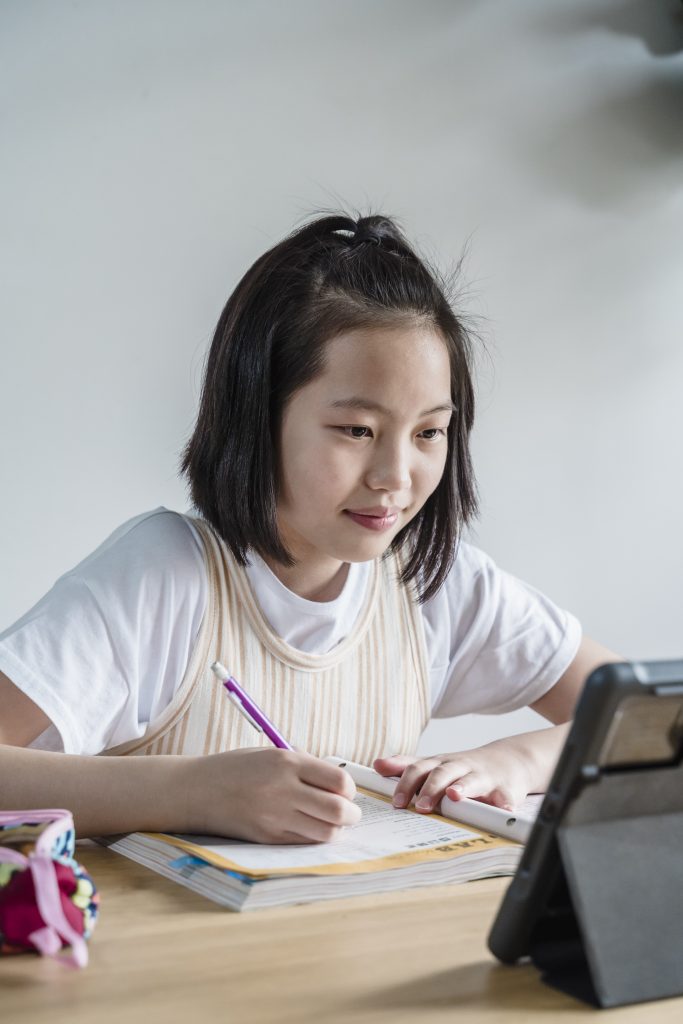 A girl attending online schooling