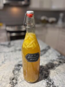 A bottle of pineapple mango kombucha.