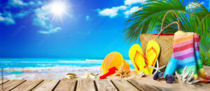 Tropical beach with sunbathing accessories, summer holiday background