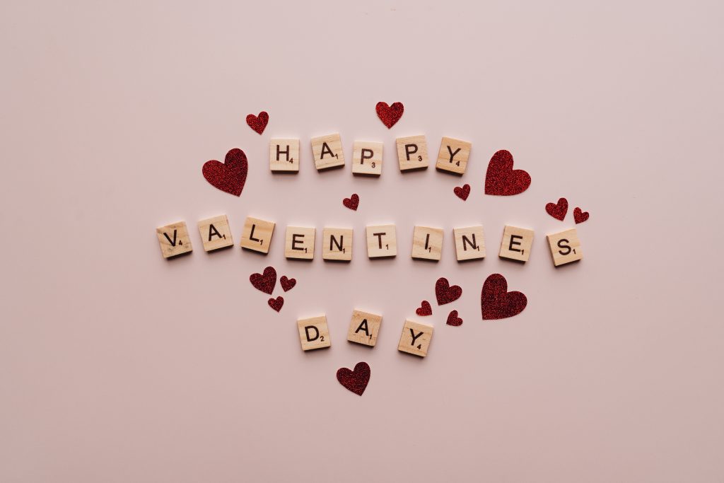 Happy valentine s day text on pink surface