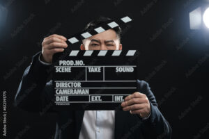 Asian actor with clapperboard on stage. Film industry