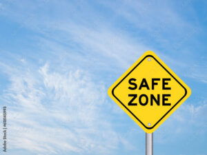 Yellow transportation sign with word safe zone on blue color sky background
