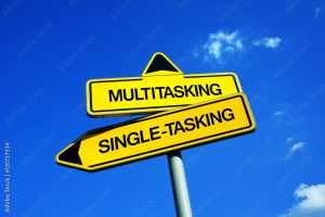Multitasking vs Single-tasking - Traffic sign with two options - concentration and focus on one task and activity or effective and productive performance because of concurrence and simultaneity