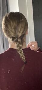 single braid on the back of a head starting in a low ponytail style