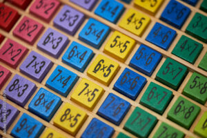 Multiplication table . Macro mode. Colored wooden cubes. Teaching children math and numeracy. Mental math.