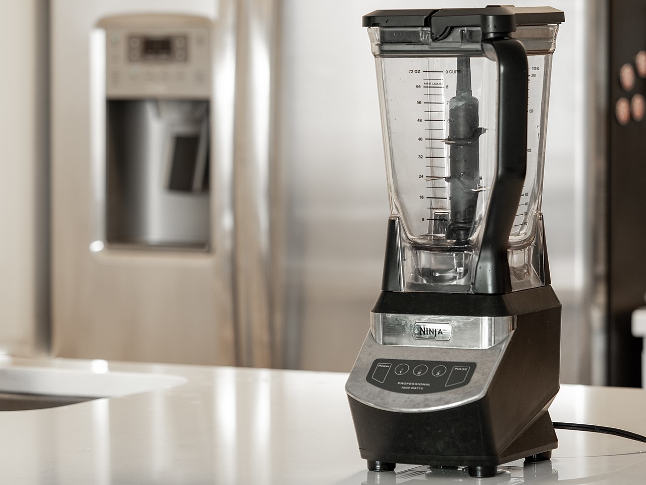 A picture of a blender sitting on a kitchen counter.