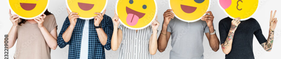 Diverse people holding happy emoticons