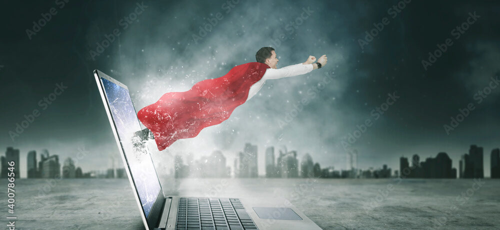 Businessman in red cape flying out of laptop screen