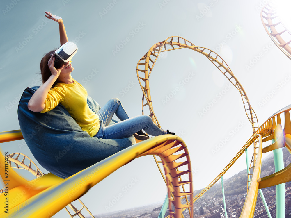 Young woman used Virtual reality helmet VR. She see Roller-coaster park
