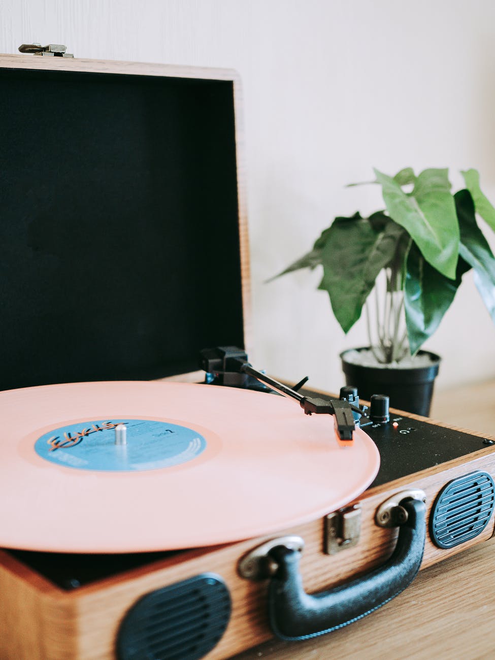 pink vinyl record put on turntable of record player