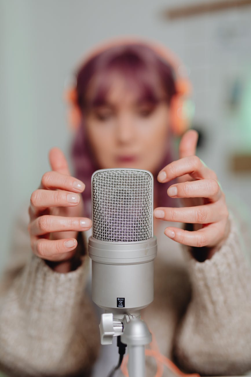 a woman touching a microphone